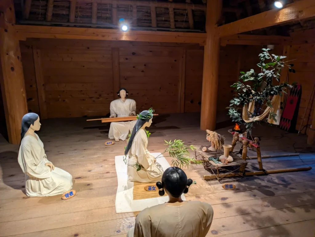 A recreated ritual by a shaman inside the Main Ritual Hall at the Yoshinogari Site